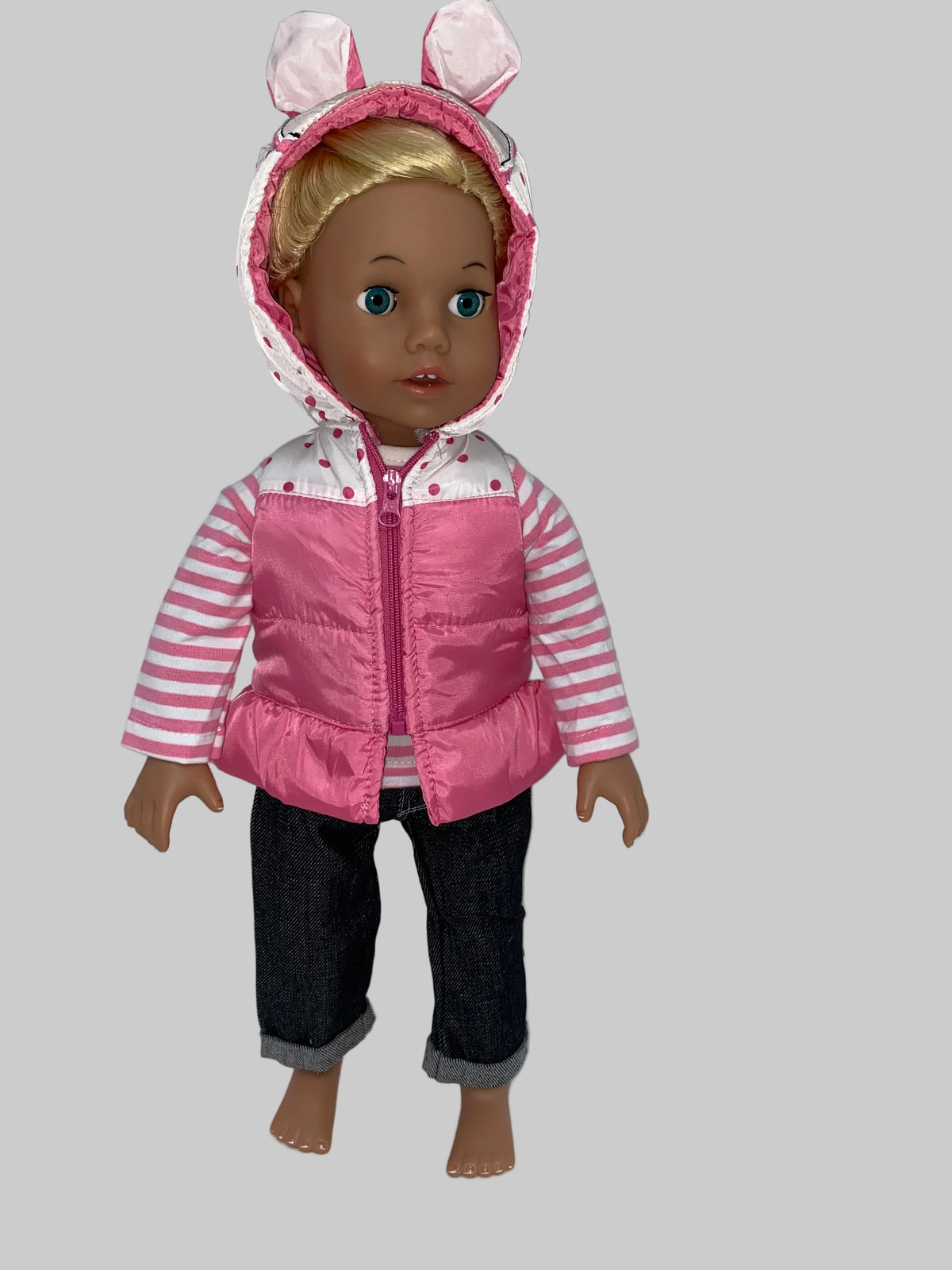 Full outfit, plain background — "Full outfit view on 18 inch doll showing pink satin puffer vest with zip front, polka dot and bunny ear hood, pink and white striped long-sleeve shirt, and dark denim cuffed jeans, on plain background"